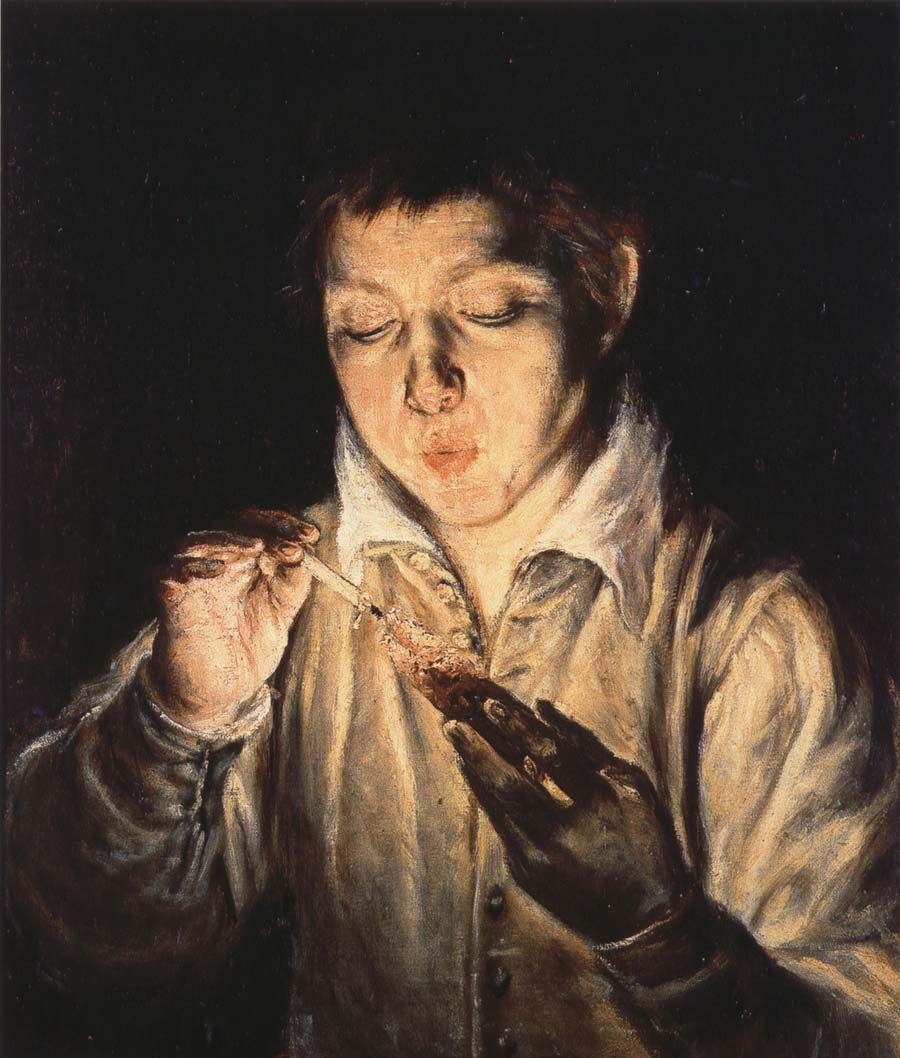 A Boy blowing on an Ember to light a candle